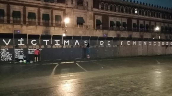 Activistas graban los nombres de víctimas de feminicidios en las vallas de Palacio Nacional