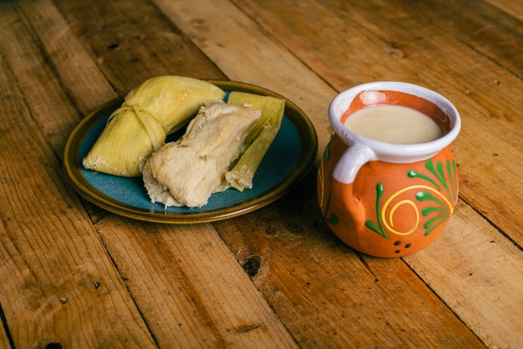 tamales de elote and atole on a wooden table typi 2023 11 27 05 32 33 utc 1